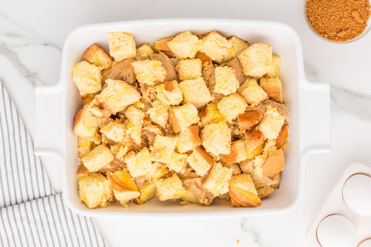 bread cubes placed on top of biscoff mixture