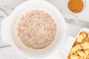 eggs, milk, cream, vanilla, and cinnamon in a bowl