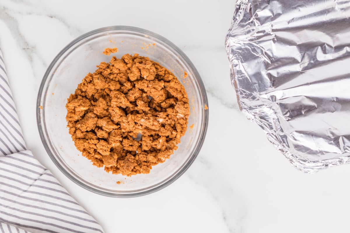 cold butter with the cookie crumbs mixed in a bowl