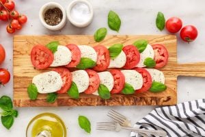 salt and pepper added to top of tomatoes and cheese