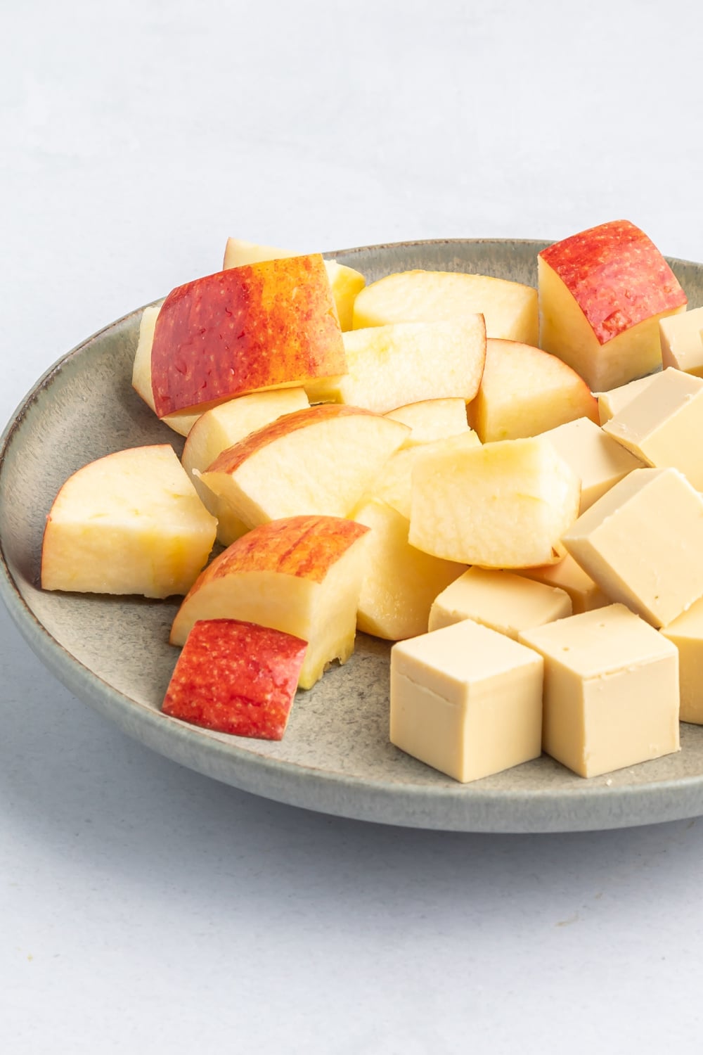 apple and cheese cubes on a plate