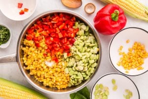 frozen corn, frozen baby lima beans, diced red bell pepper, and sea salt added to pan