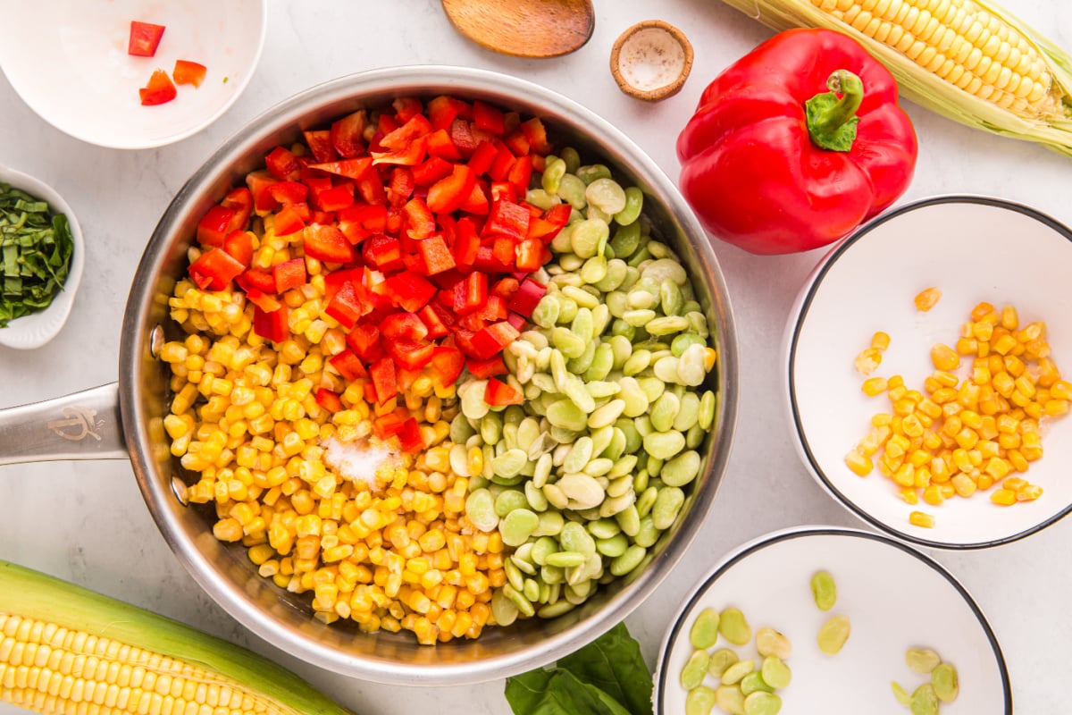 frozen corn, frozen baby lima beans, diced red bell pepper, and sea salt added to pan