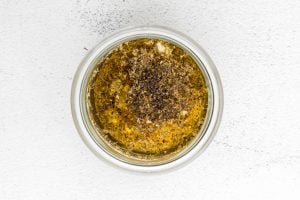 extra virgin olive oil, red wine vinegar, garlic, lemon juice, oregano, honey, salt, and pepper in a jar