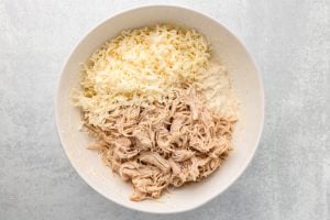shredded chicken and Monterey Jack cheese in a bowl