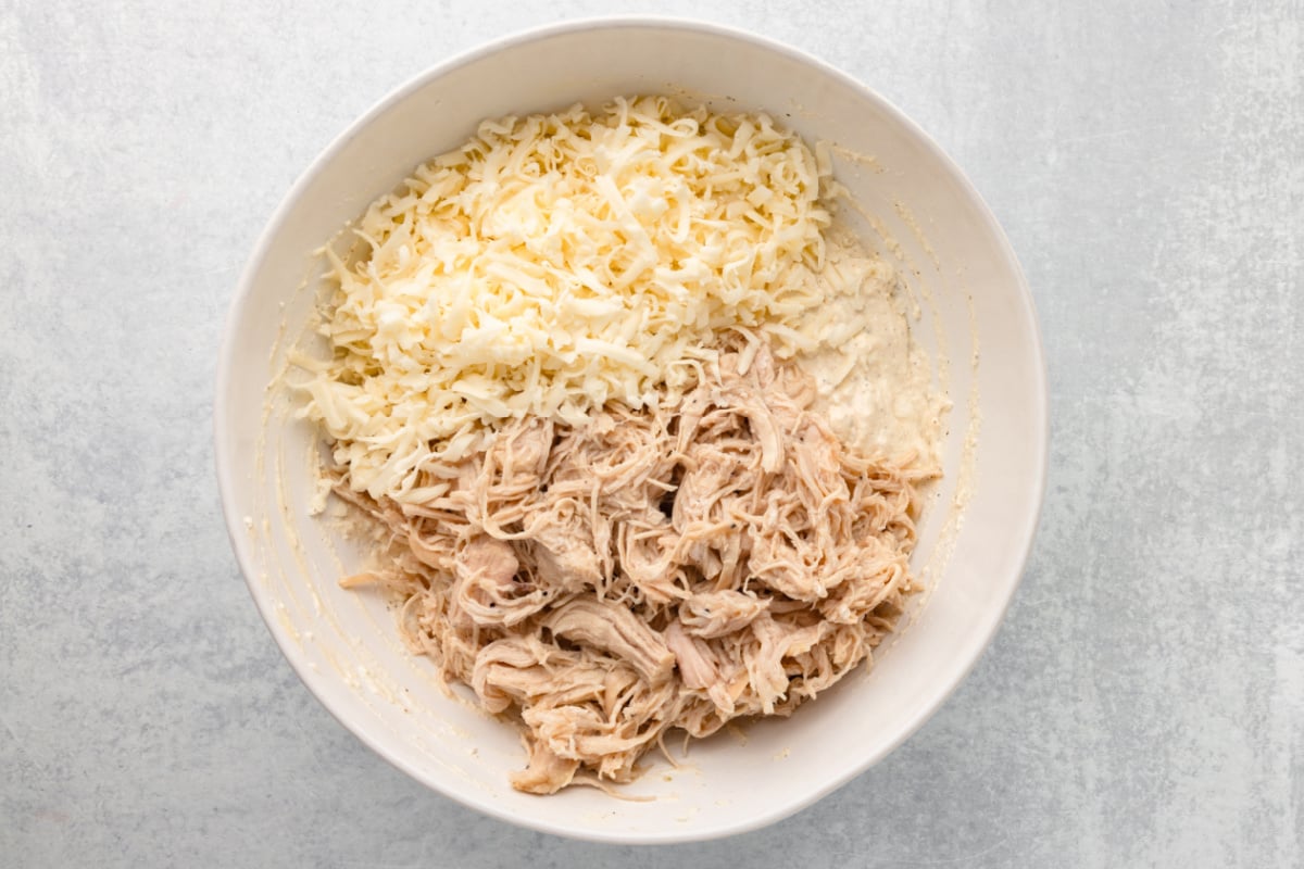 shredded chicken and Monterey Jack cheese in a bowl