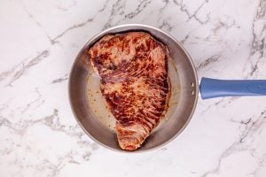 searing meat in a pan