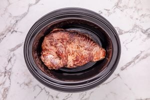 seared meat placed in crockpot