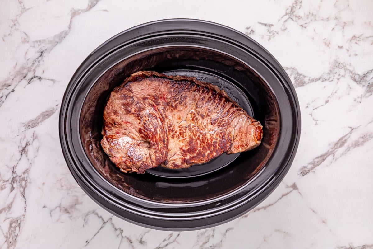 seared meat placed in crockpot