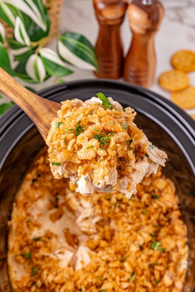 Slow Cooker Ritz Cracker Chicken Casserole in a slow cooker with wooden spoon