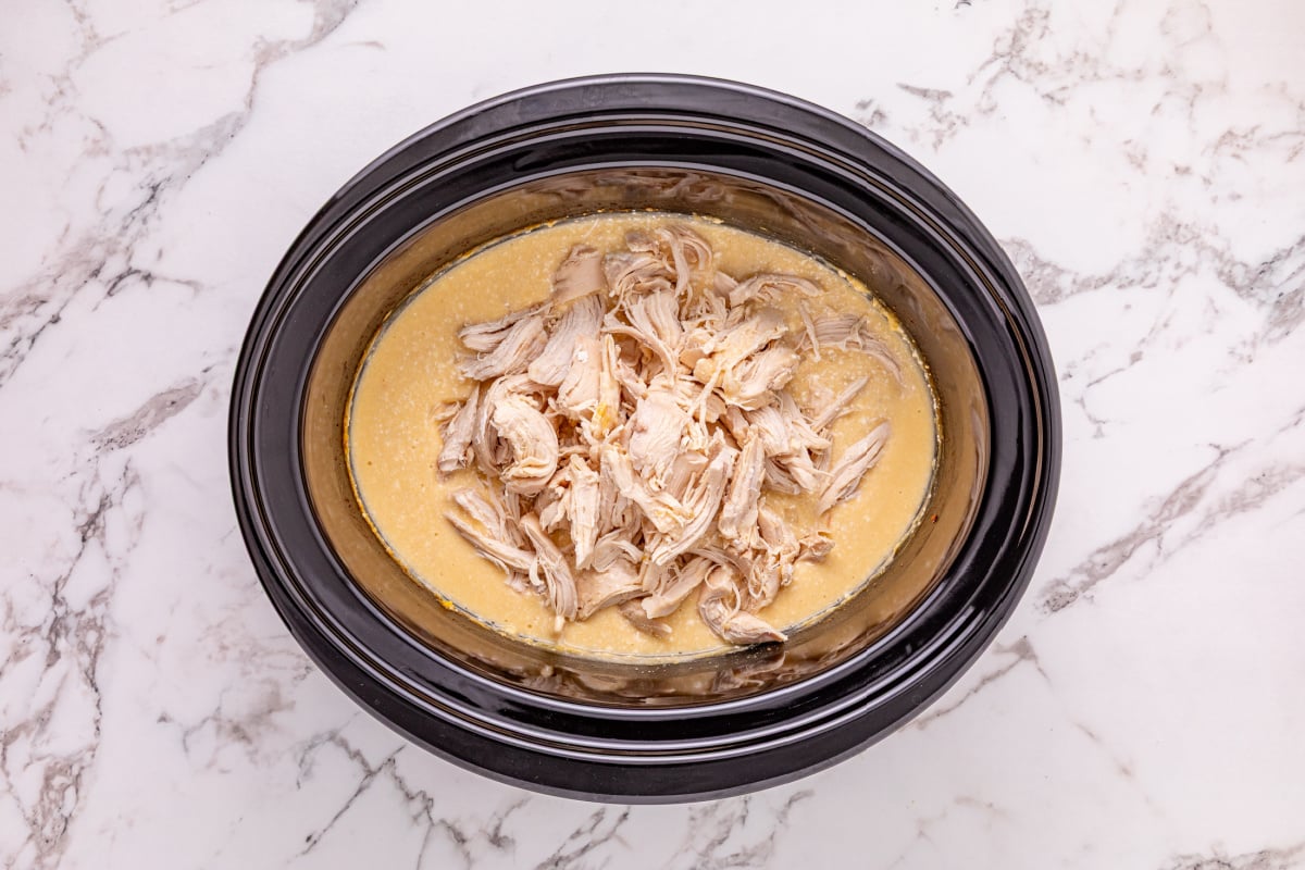 shredded chicken placed in slow cooker
