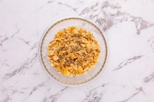 crumbled Ritz crackers and Italian seasoning added to bowl with butter