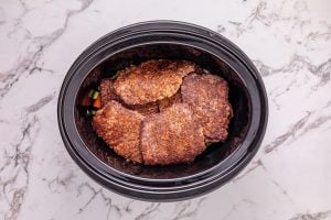 browned beef added to top of veggies