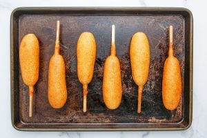 corn dogs on baking sheet