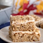 Banana Nut Bars with Cream Cheese Frosting stacked on a plate
