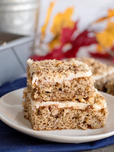 Banana Nut Bars with Cream Cheese Frosting stacked on a plate
