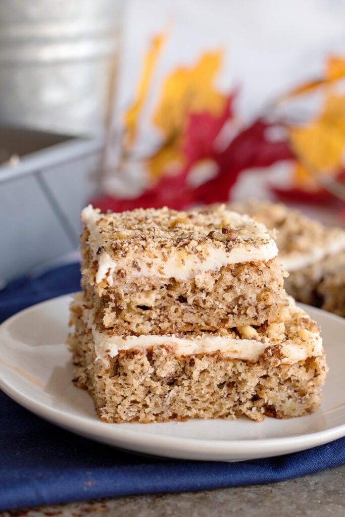Banana Nut Bars with Cream Cheese Frosting stacked on a plate