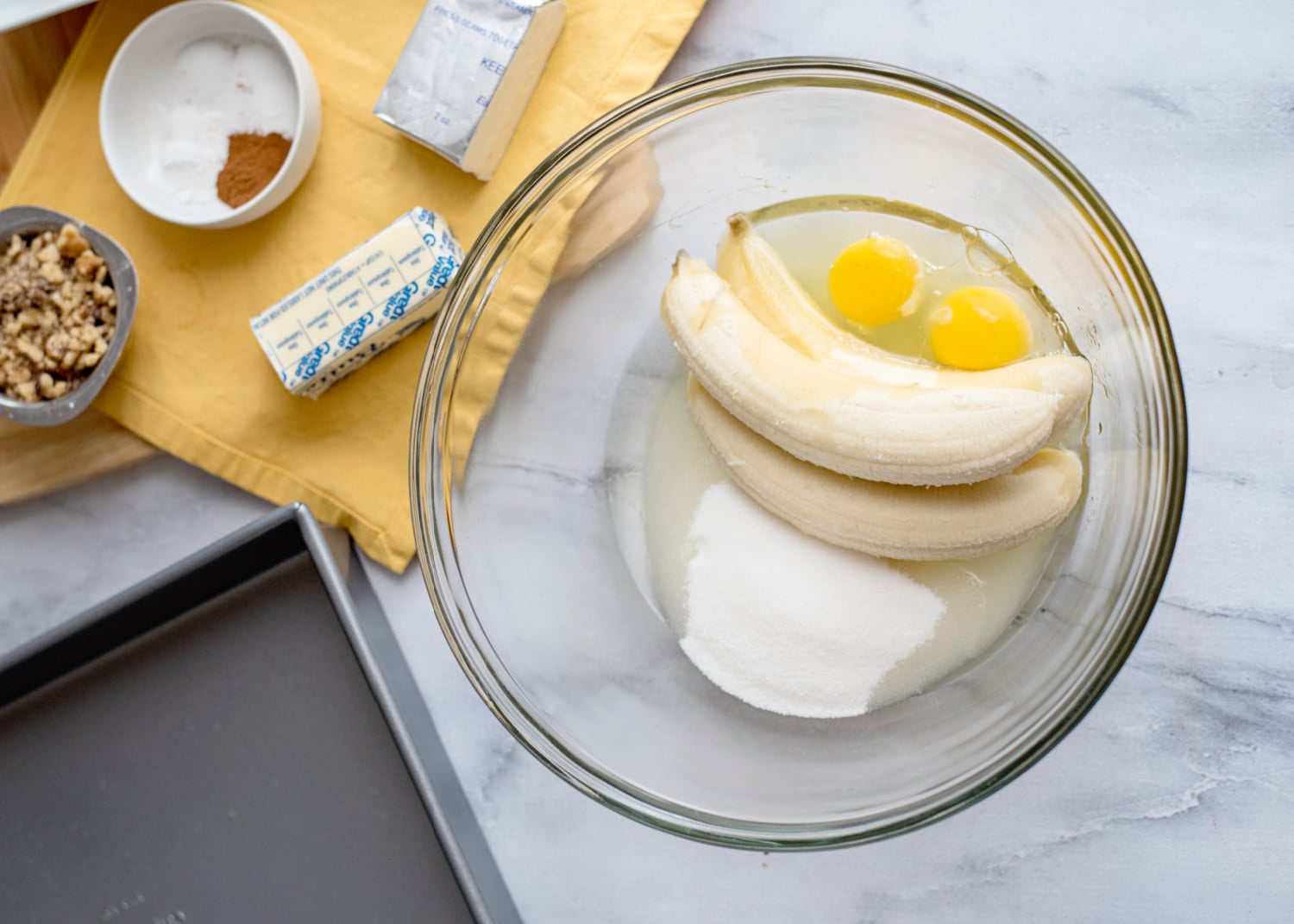 sugar, bananas, vegetable oil, and eggs in a bowl
