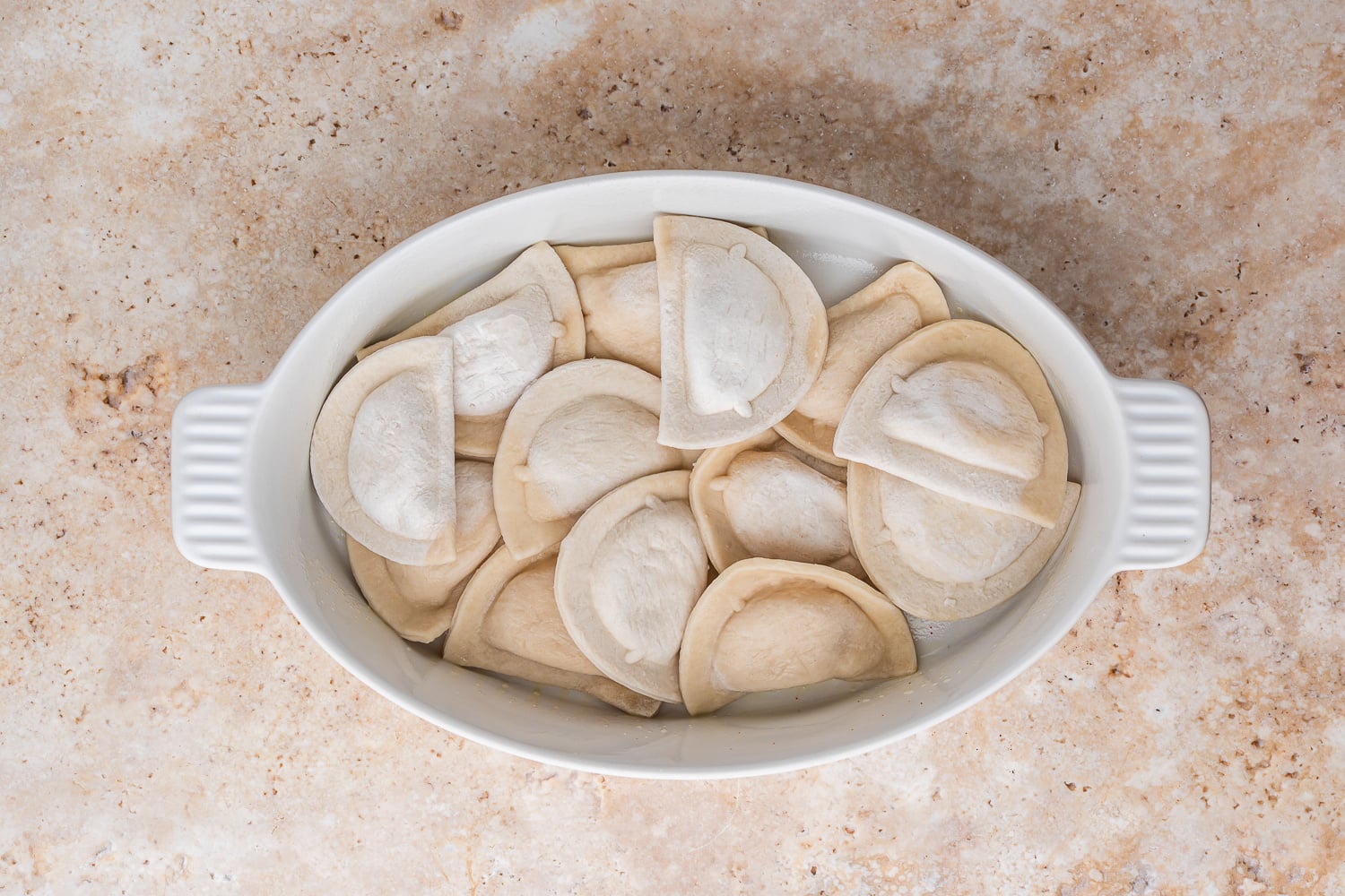 pierogi added to the bottom of the baking dish