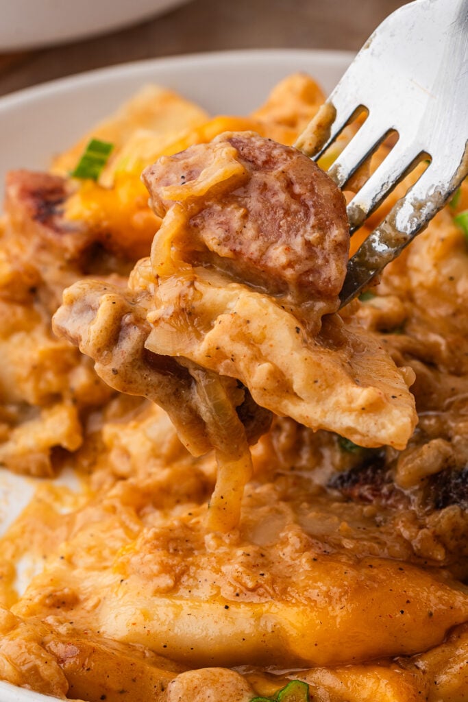 fork picking up Easy Pierogi Casserole with Kielbasa