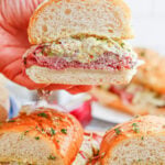 Hand picking up a Grinder Sub Sandwich