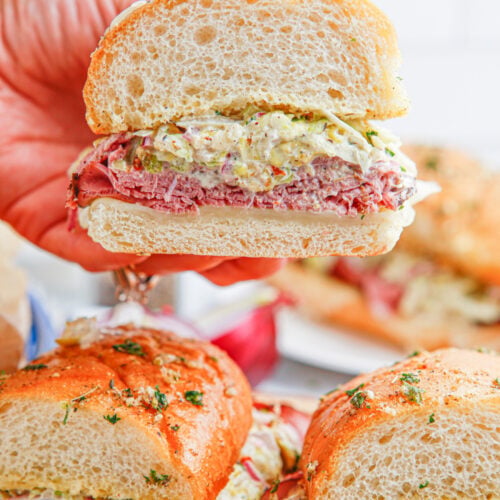 Hand picking up a Grinder Sub Sandwich
