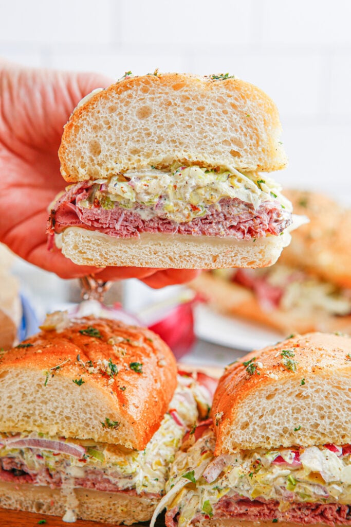 Hand picking up a Grinder Sub Sandwich
