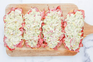 grinder salad placed on top of sliced meat