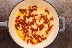 oil from the jar of sundried tomatoes, and the garlic in a pan