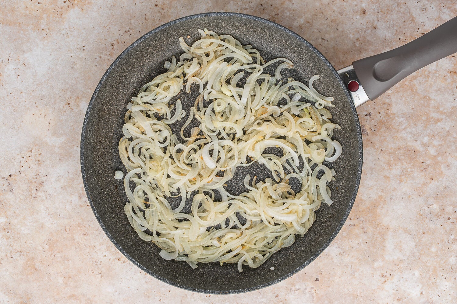 onions cooking in a pan