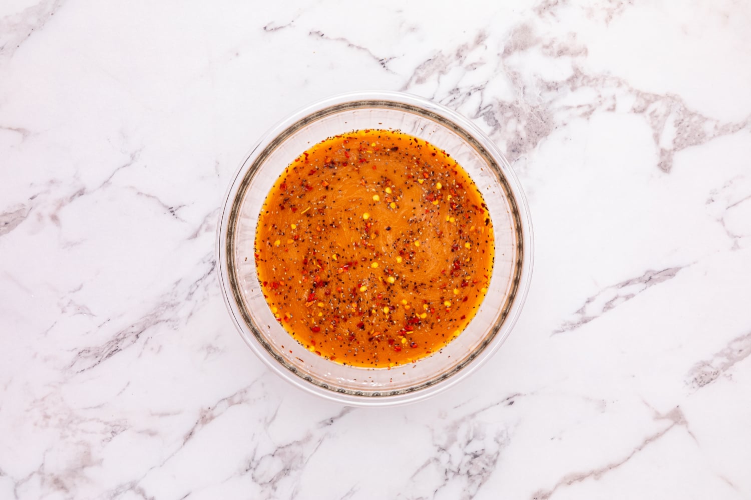 beef broth, soy sauce, cornstarch, sugar, red pepper flakes, salt, and pepper mixed in a bowl