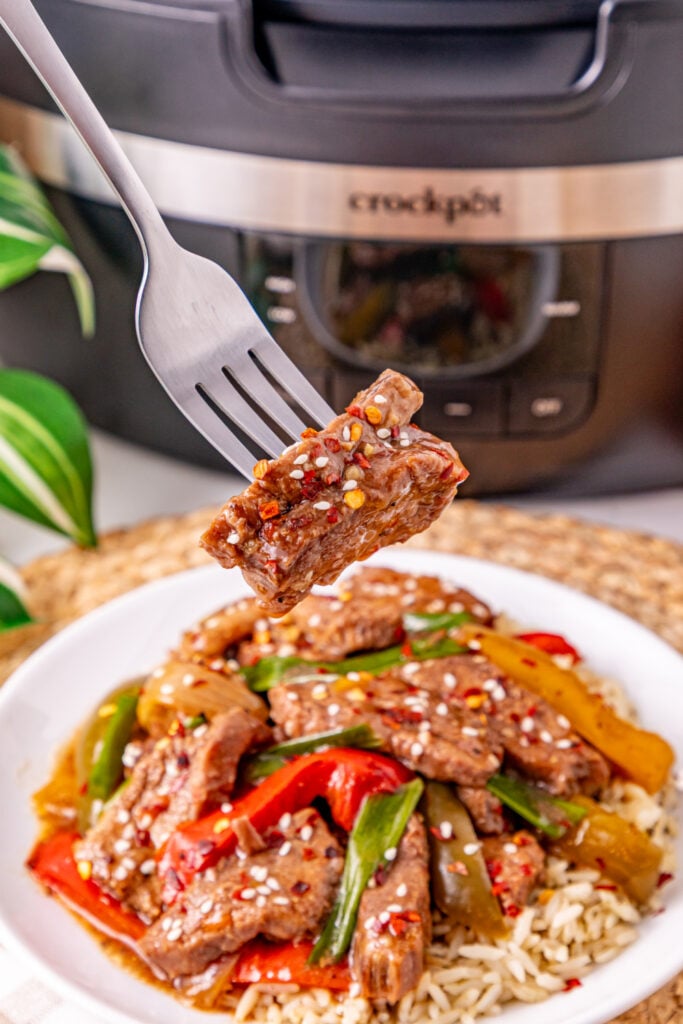 fork picking up Slow Cooker Pepper Steak