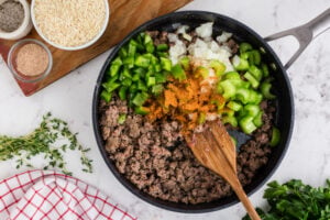 diced onion, green bell pepper, seasoning and celery added to pan