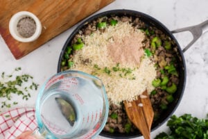 rice, beef bouillon, water, and thyme sprigs added to pan