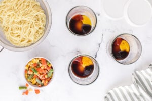 hoisin sauce, soy sauce, sriracha sauce, and lemon juice added to jars