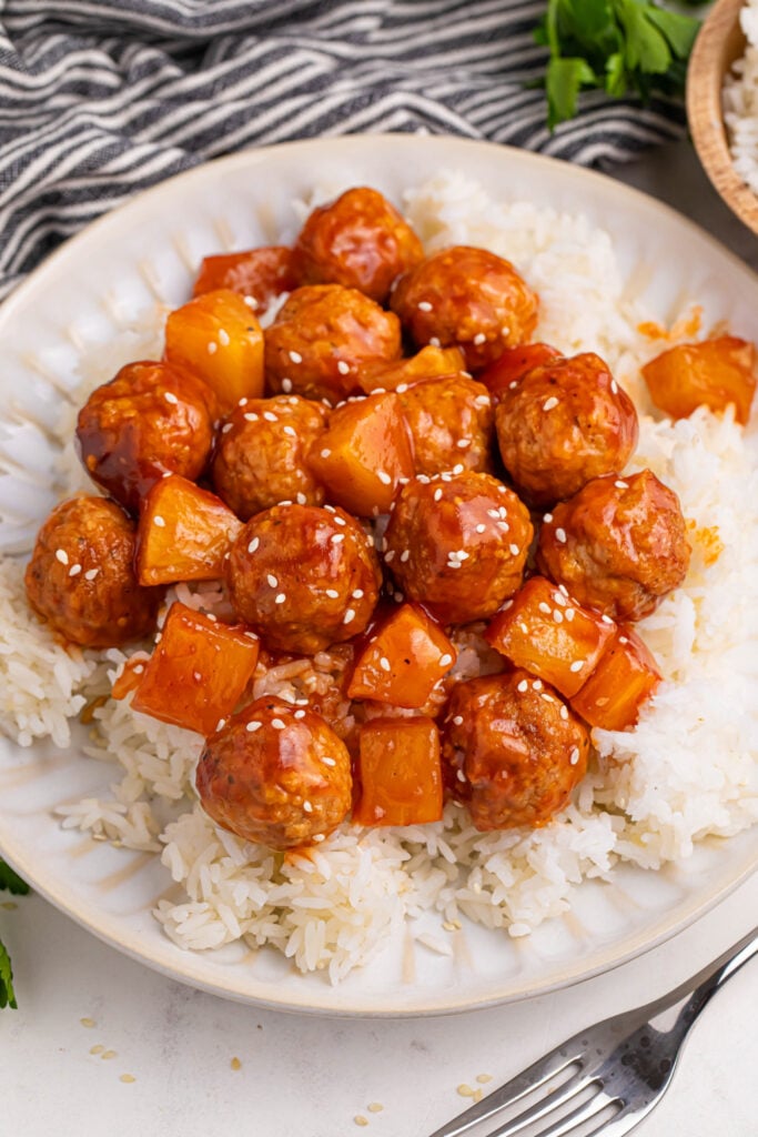 Slow Cooker 3 Ingredient Hawaiian Meatballs served over rice on a plate