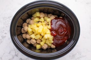 BBQ sauce and pineapple chunks, including the juice added to crock pot