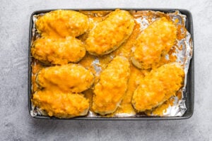 cooked Buffalo Chicken Stuffed Potatoes on a baking sheet