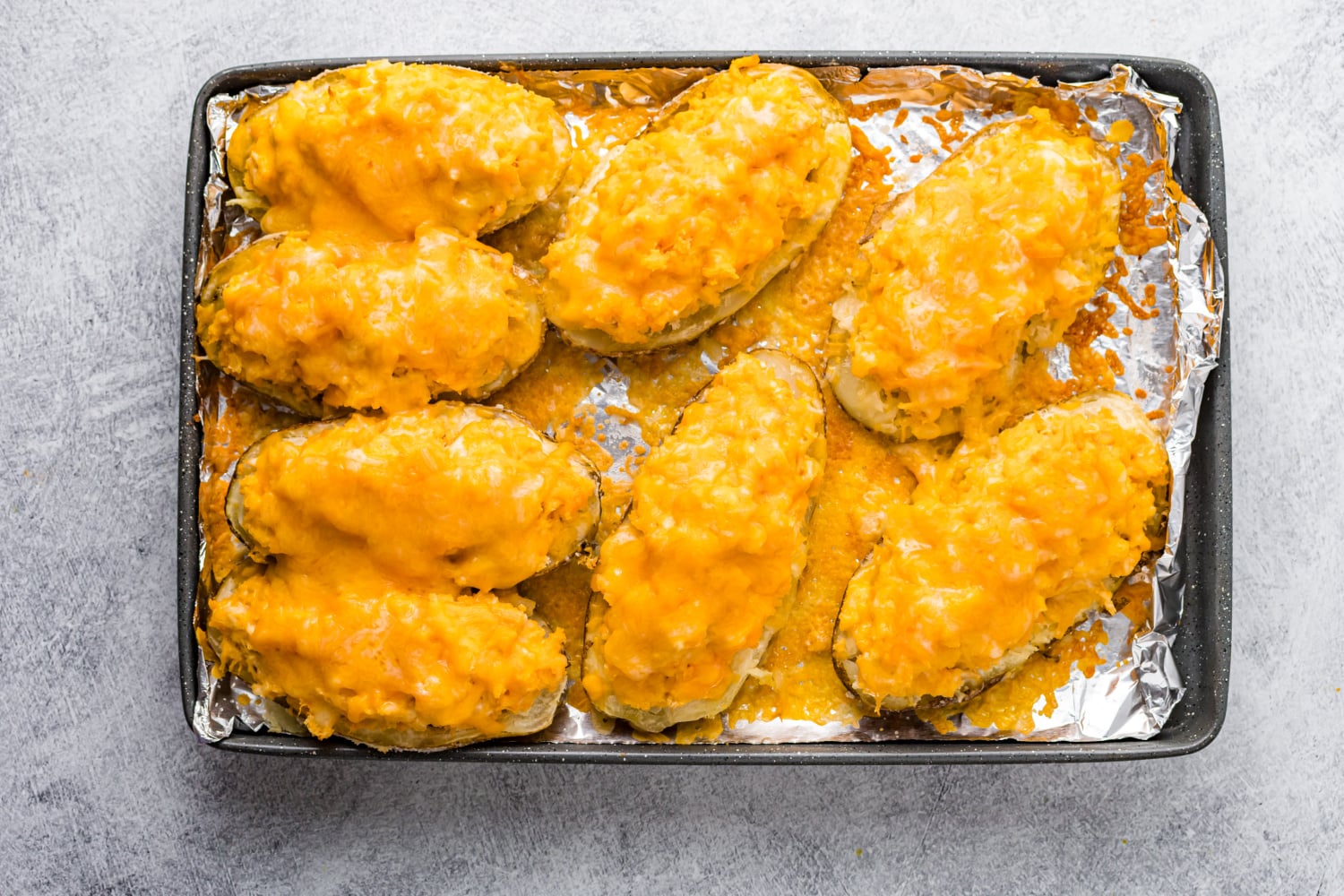 cooked Buffalo Chicken Stuffed Potatoes on a baking sheet