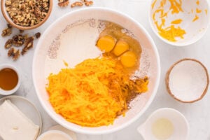 grated butternut squash, eggs, heavy cream, and vegetable oil added to bowl
