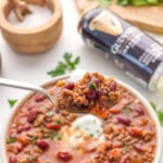 scooping up chili with a spoon