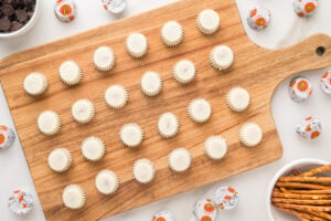 unwrapped mini peanut butter cups on a cutting board