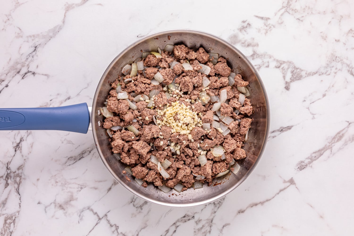 ground beef, onion and garlic in a pan