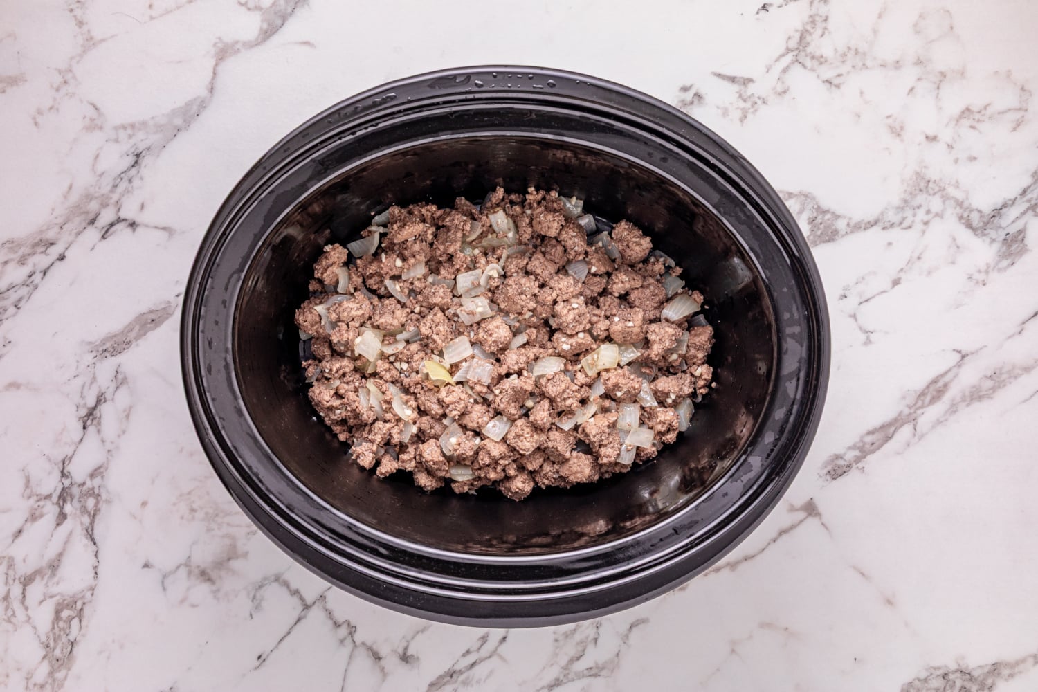 cooked beef and onion in slow cooker