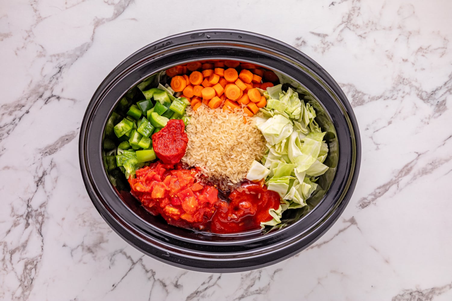 carrots, bell pepper, rice, cabbage, diced tomatoes, tomato sauce, and worcestershire sauce added to slow cooker